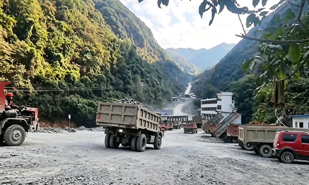 Several dump trucks at an outdoor work area.